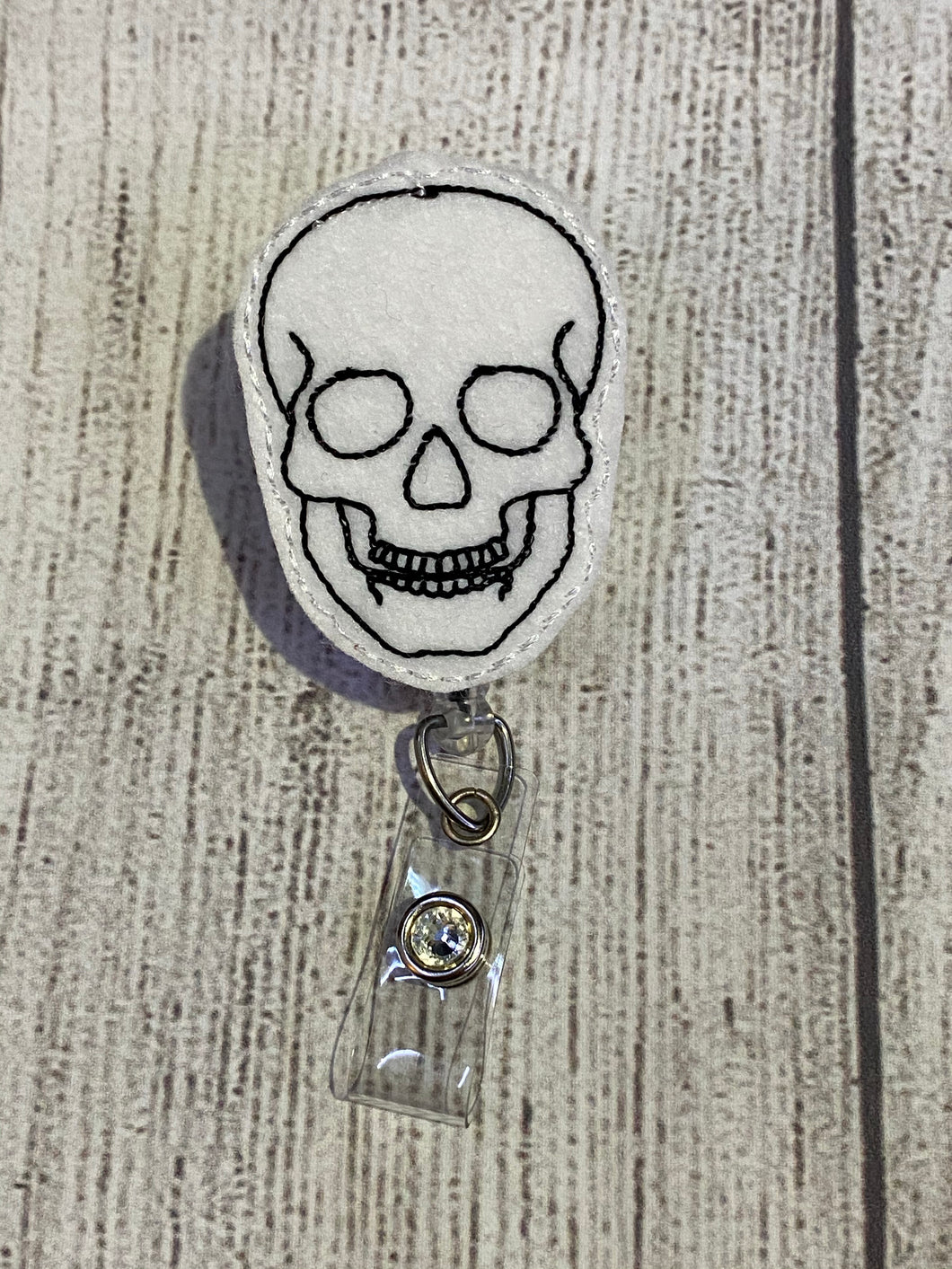 Skull badge reel